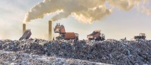 PFAS in Landfills. Garbage trucks moving trash in a landfill.